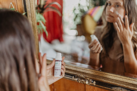 women applying powerhouse moisturizer in front of mirror