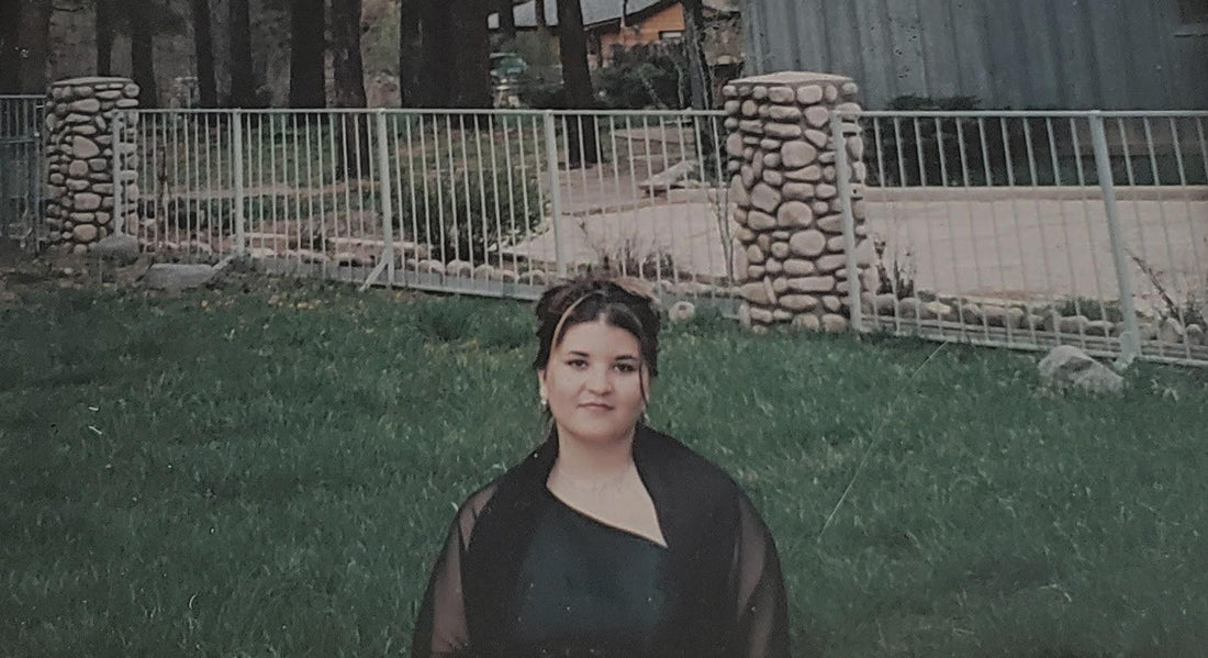 picture of girl in dress against grass background and fence