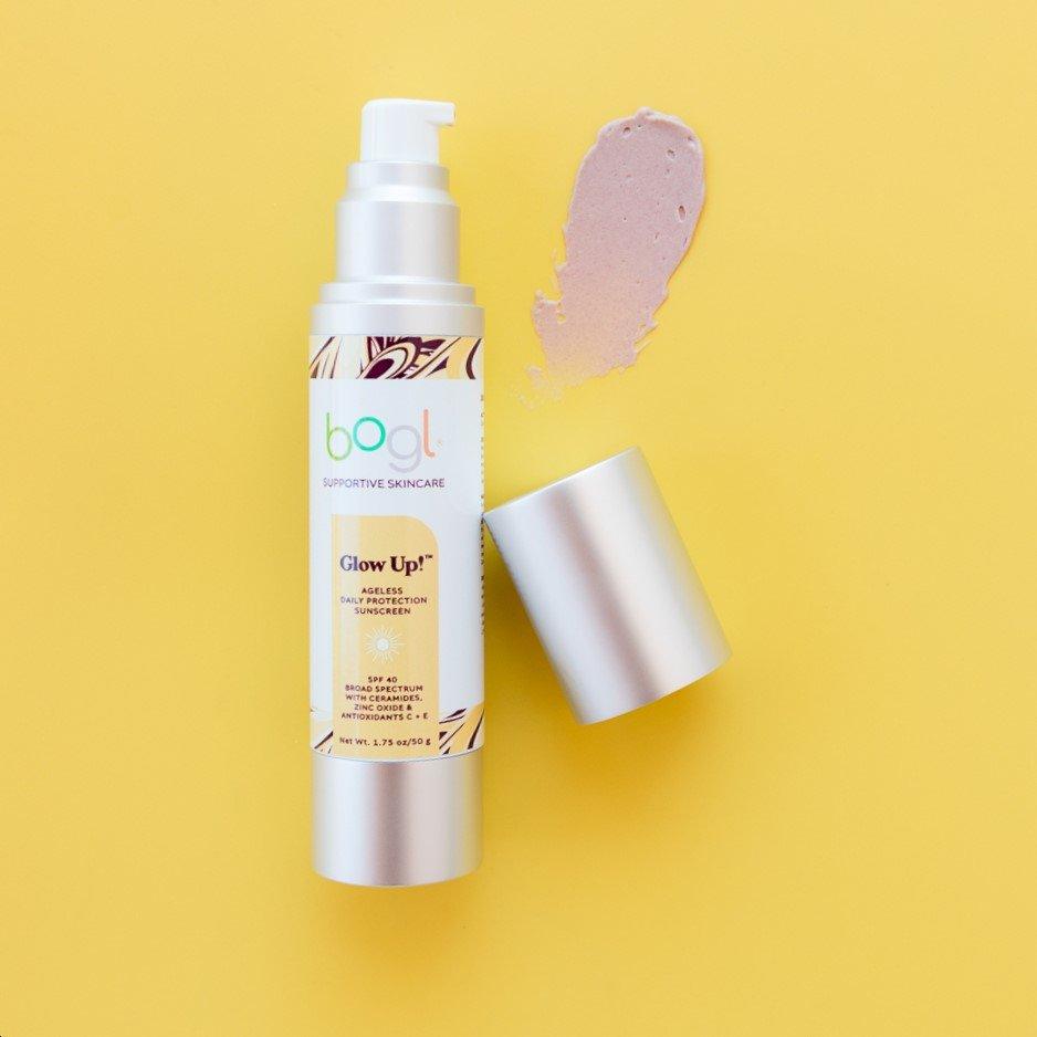 bogl's tinted, dewy glow SPF 40 in 1.75 oz bottle product smear on yellow background