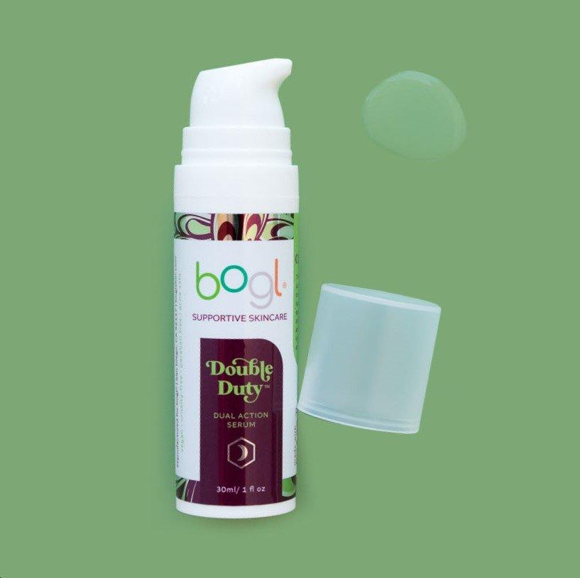 light white product smear of double duty mandelic acid on green background in 1oz bottle