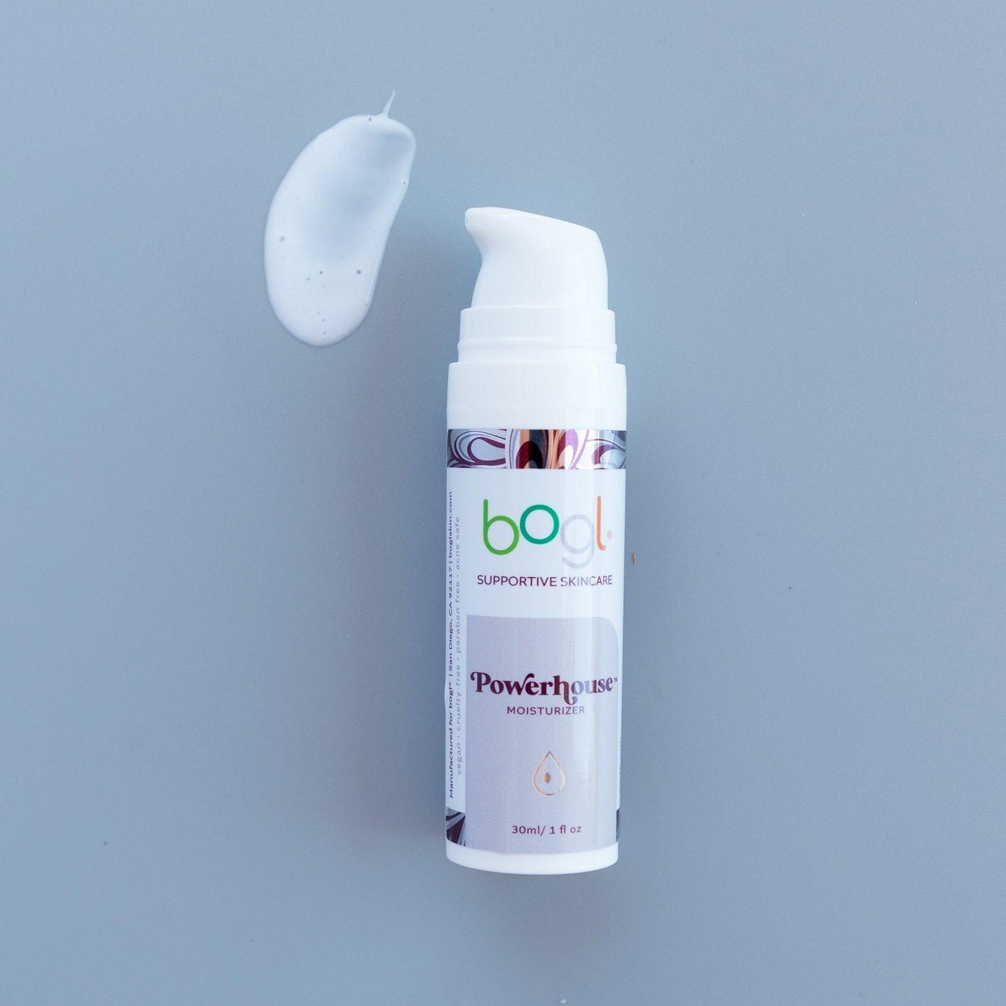 bogl's powerhouse copper peptide moisturizer light blue product smear for age management on blue background in 1 oz bottle