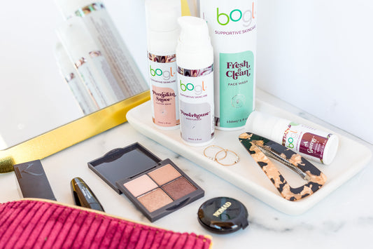 bogl products on white counter with makeup and jewerly