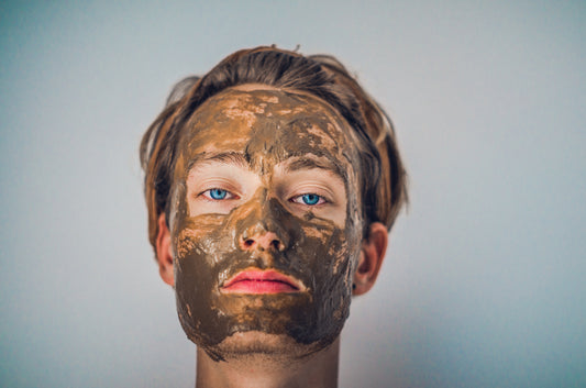 person with clay mask on face