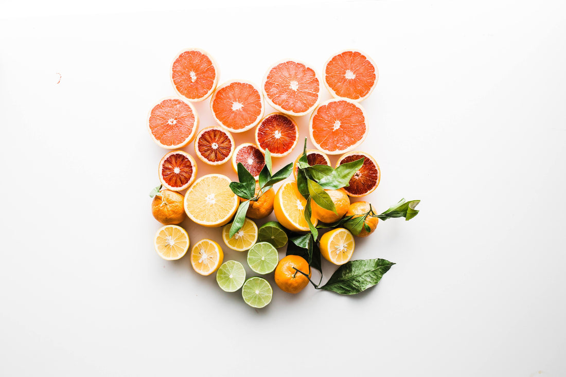 cut up various citrus fruits on white background